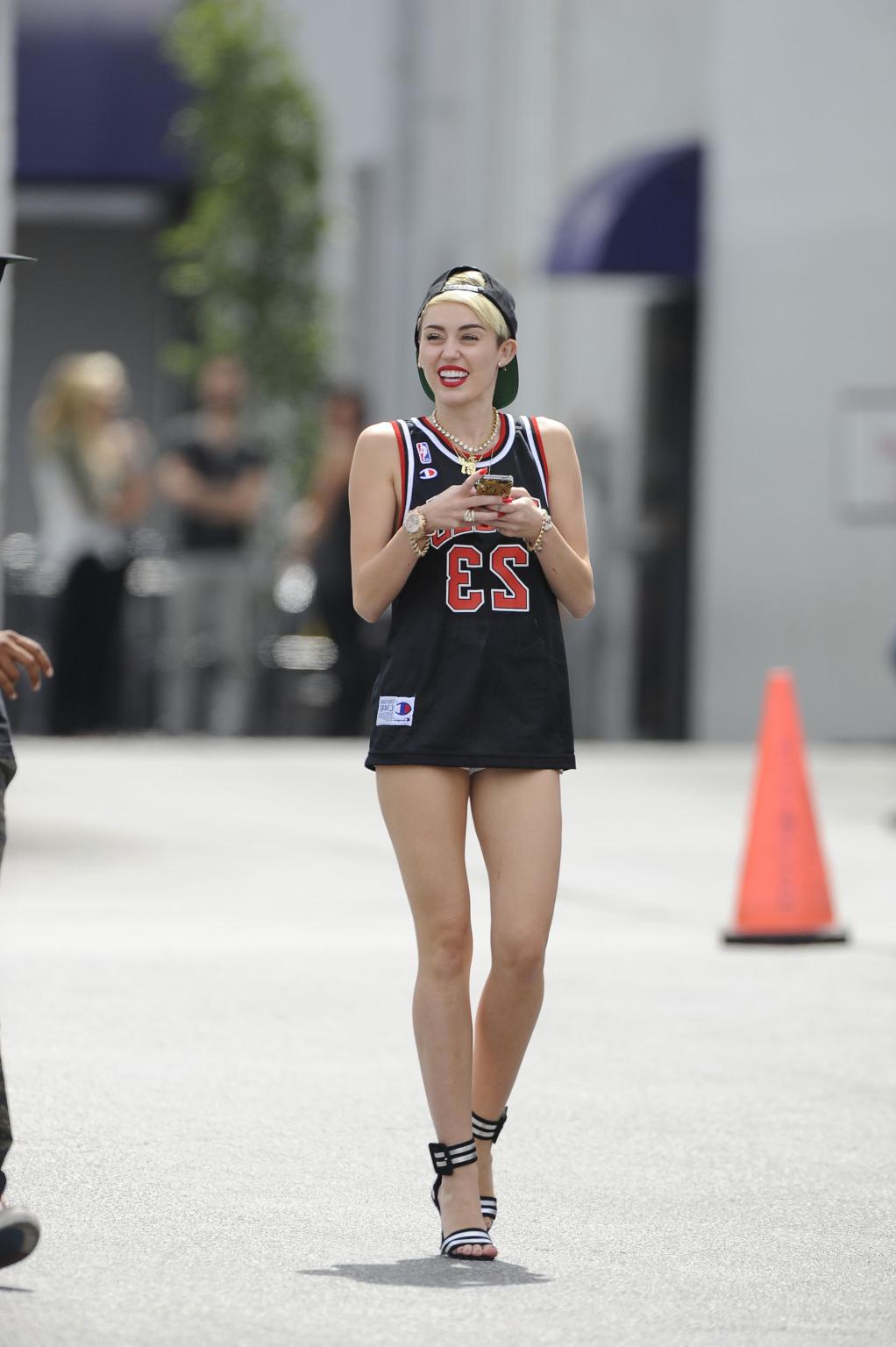 16P Miley Cyrus leggy wearing a shorts  a jersey outside a studio in LA