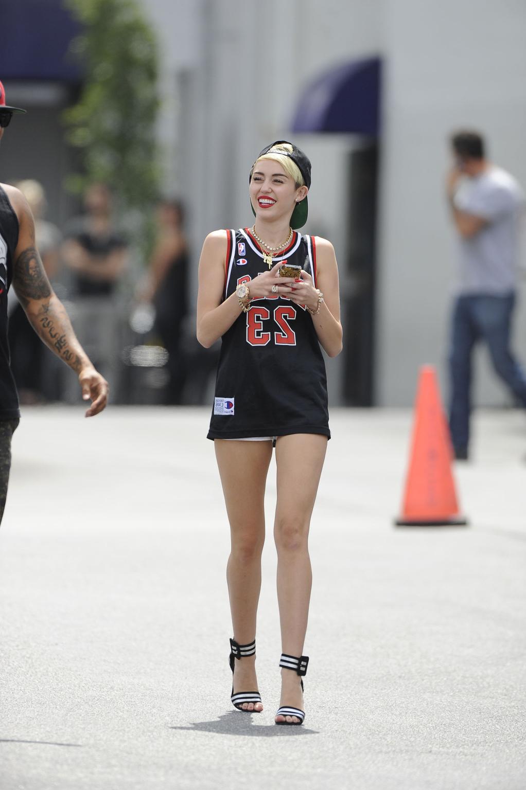 16P Miley Cyrus leggy wearing a shorts  a jersey outside a studio in LA