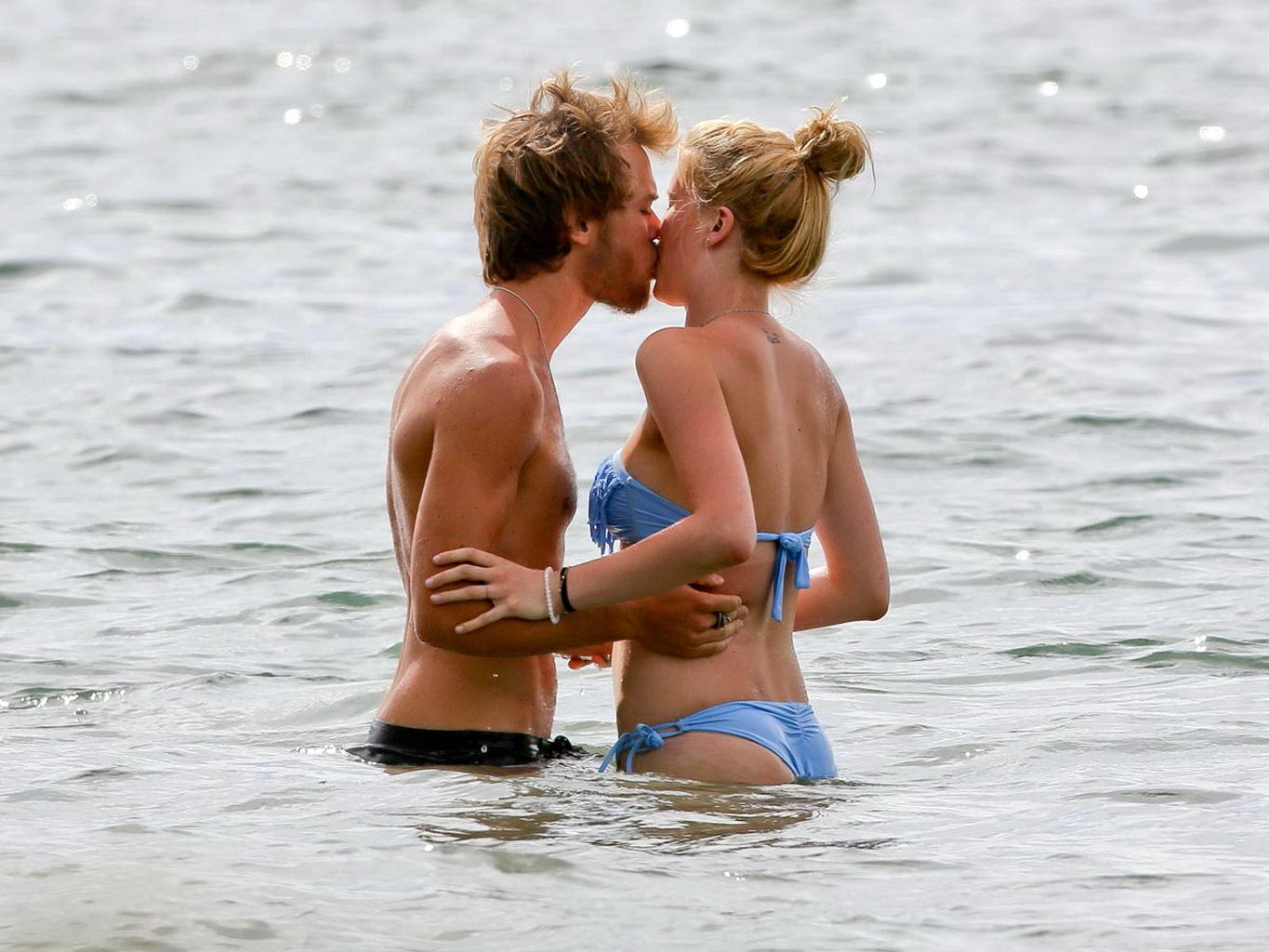 16P Ireland Baldwin nip slip wearing a tube bikini on a Hawaiian beach