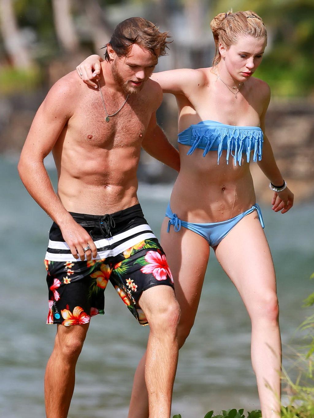 16P Ireland Baldwin nip slip wearing a tube bikini on a Hawaiian beach