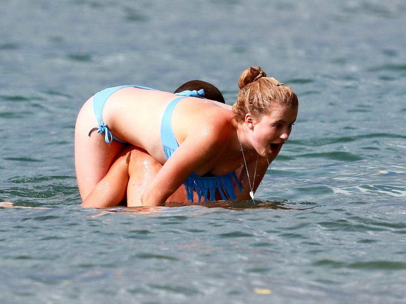 16P Ireland Baldwin nip slip wearing a tube bikini on a Hawaiian beach
