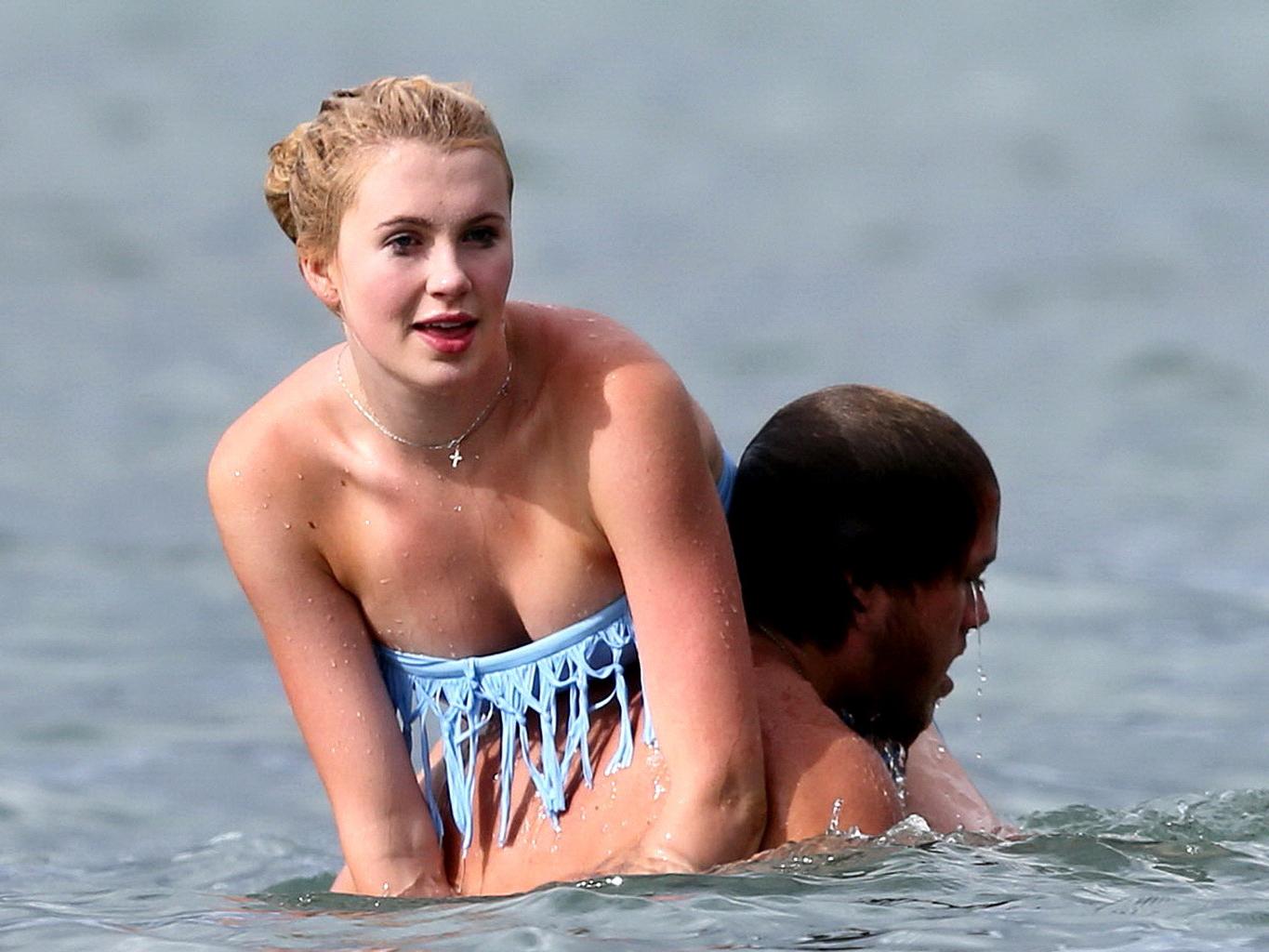 16P Ireland Baldwin nip slip wearing a tube bikini on a Hawaiian beach