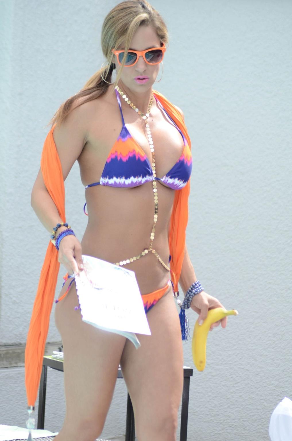 16P Jennifer Nicole Lee in bikini eating a banana poolside in LA