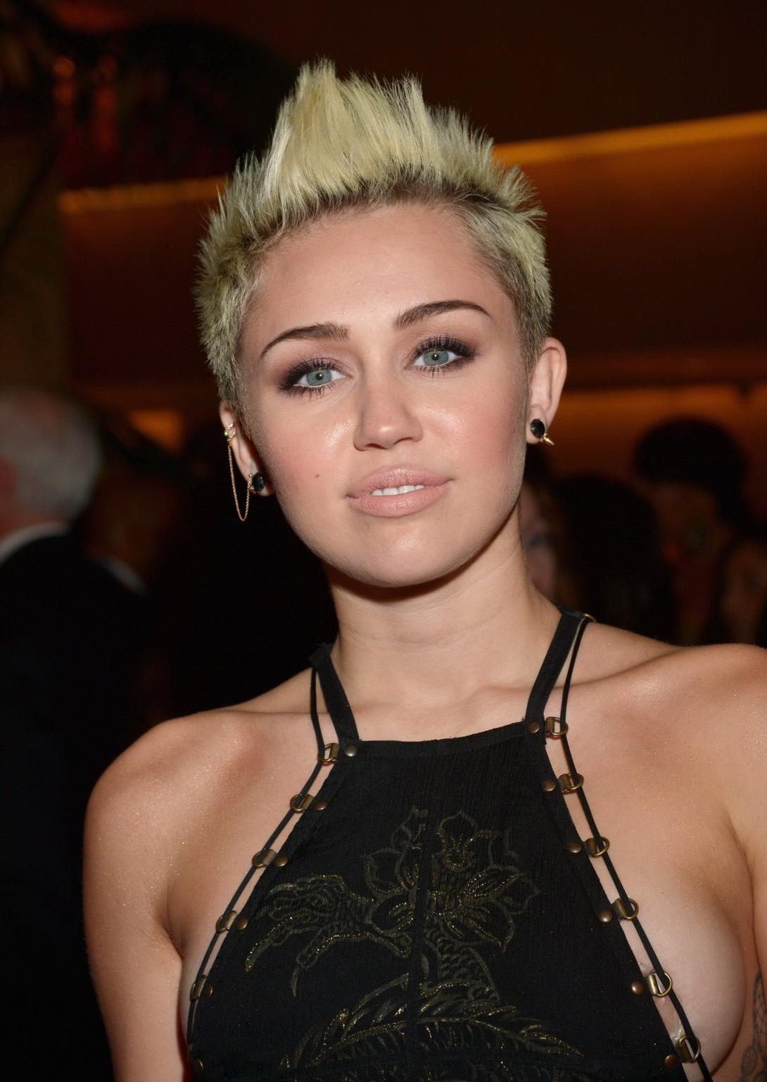 10P Miley Cyrus showing side boob in a black partially see-thru dress at Clive Davis