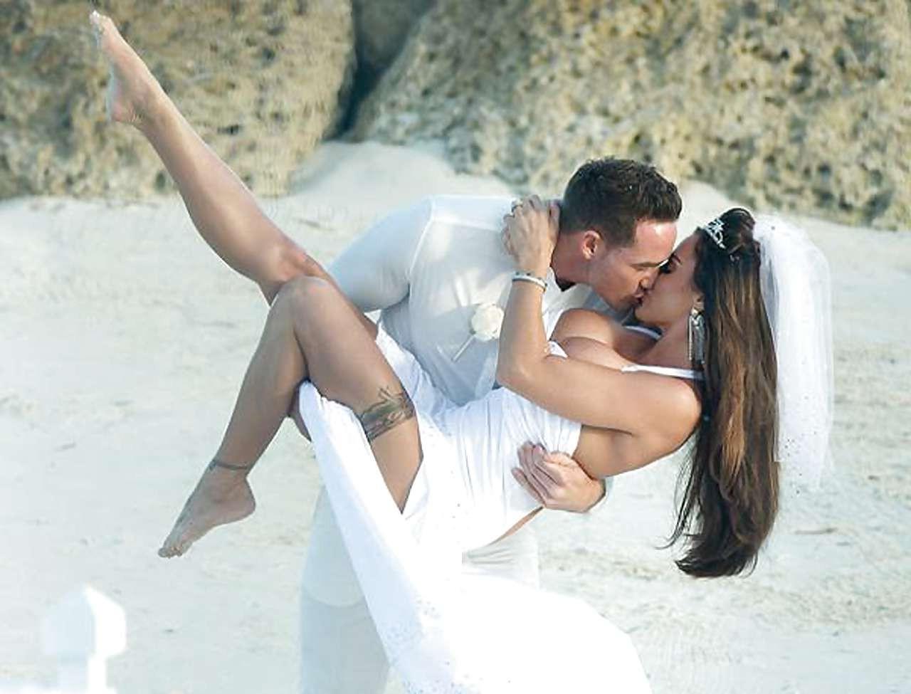 9P Katie Price sunbathing topless on beach and spreading her legs wide