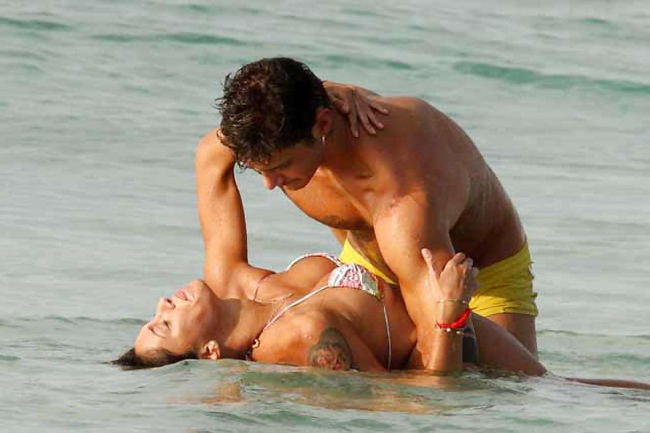 10P Belen Rodriguez exposing her boobs and ass in thong on beach