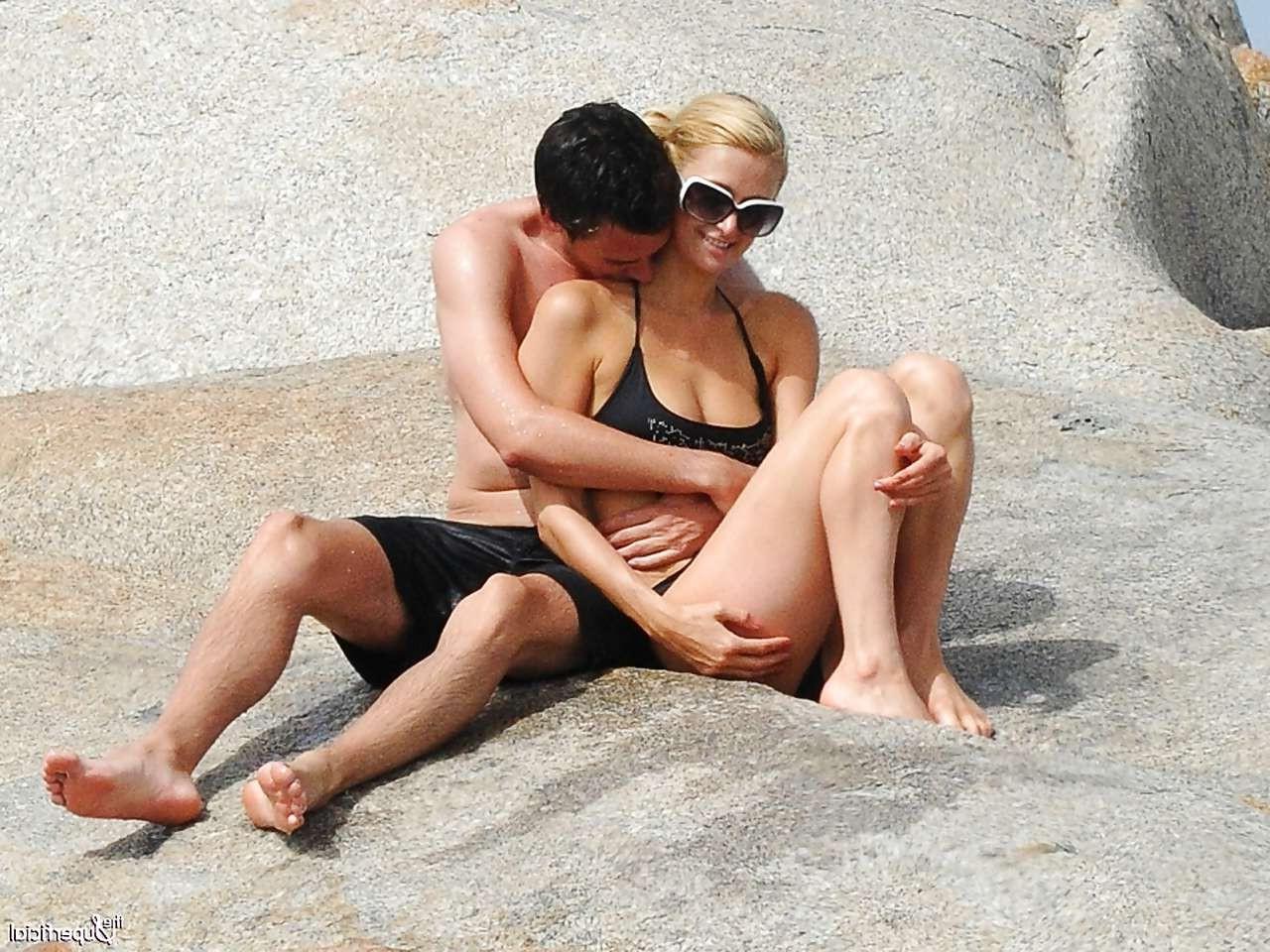 10P Paris Hilton showing her great ass in bikini thong and posing topless