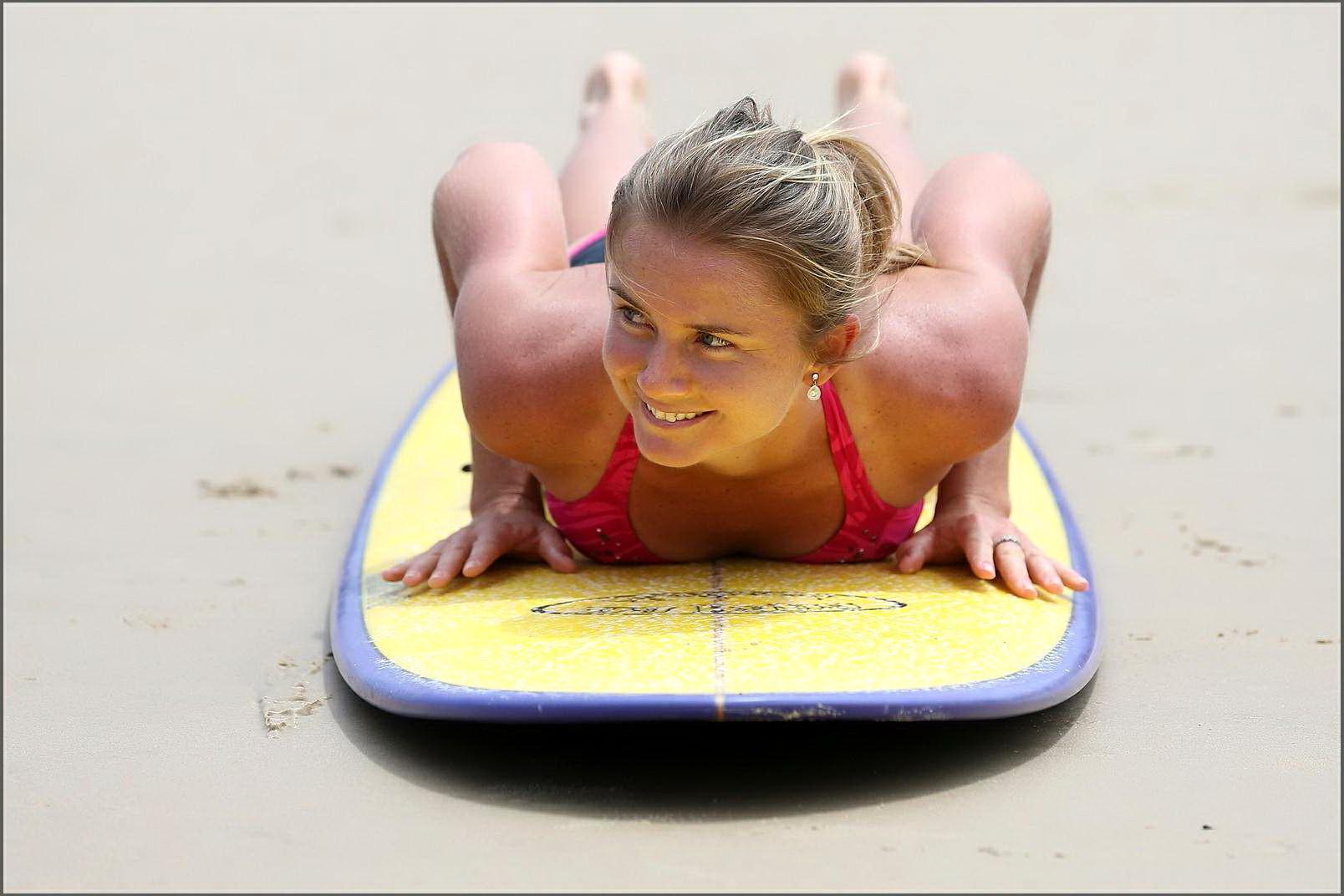 10P Daniela Hantuchova in bikini surfing on a beach in Brisbane, Australia
