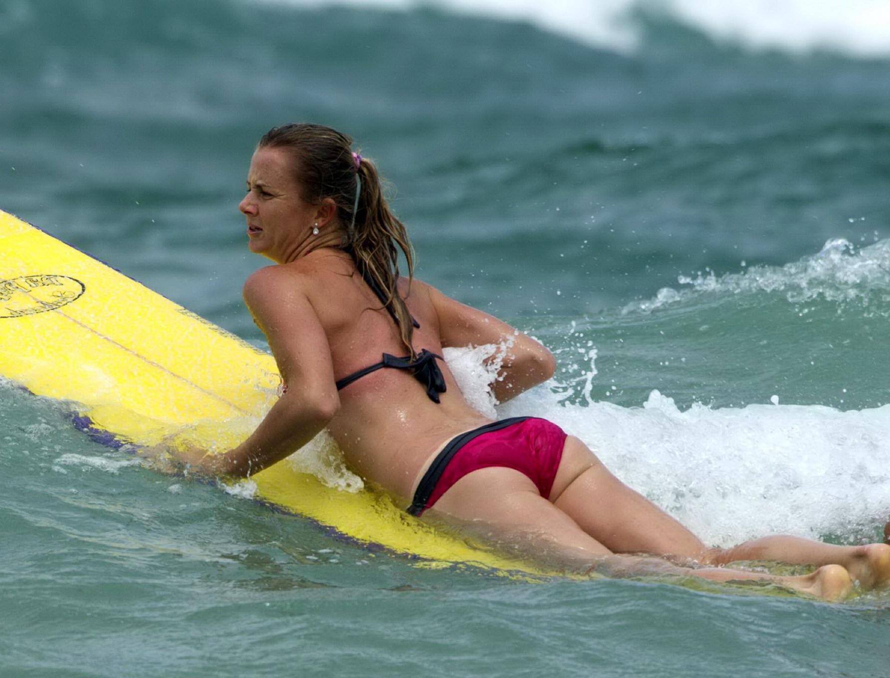 10P Daniela Hantuchova in bikini surfing on a beach in Brisbane, Australia