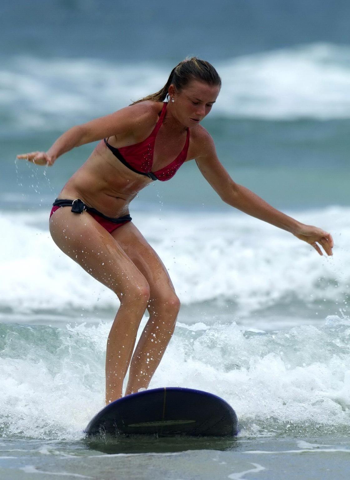 10P Daniela Hantuchova in bikini surfing on a beach in Brisbane, Australia