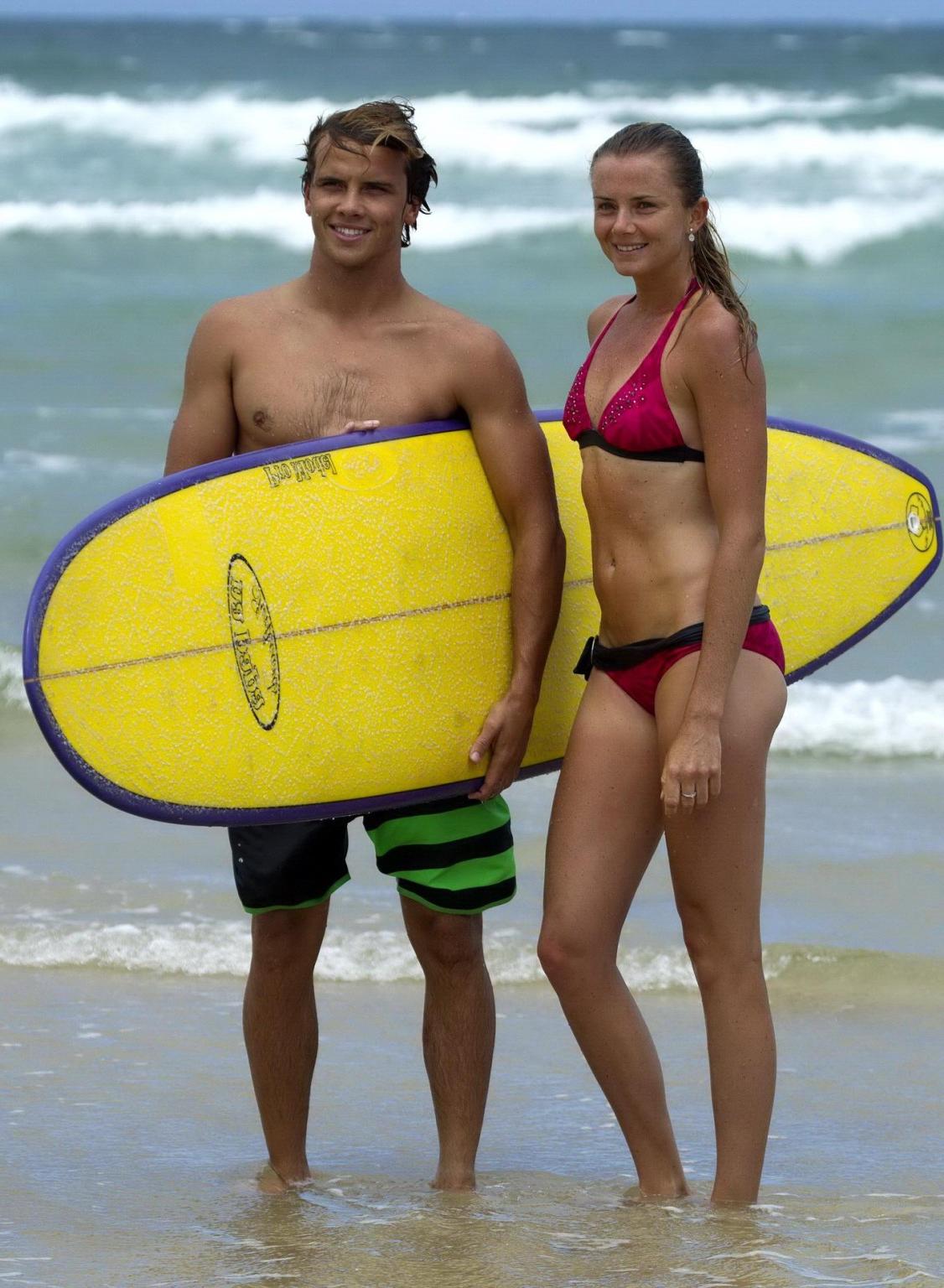 10P Daniela Hantuchova in bikini surfing on a beach in Brisbane, Australia