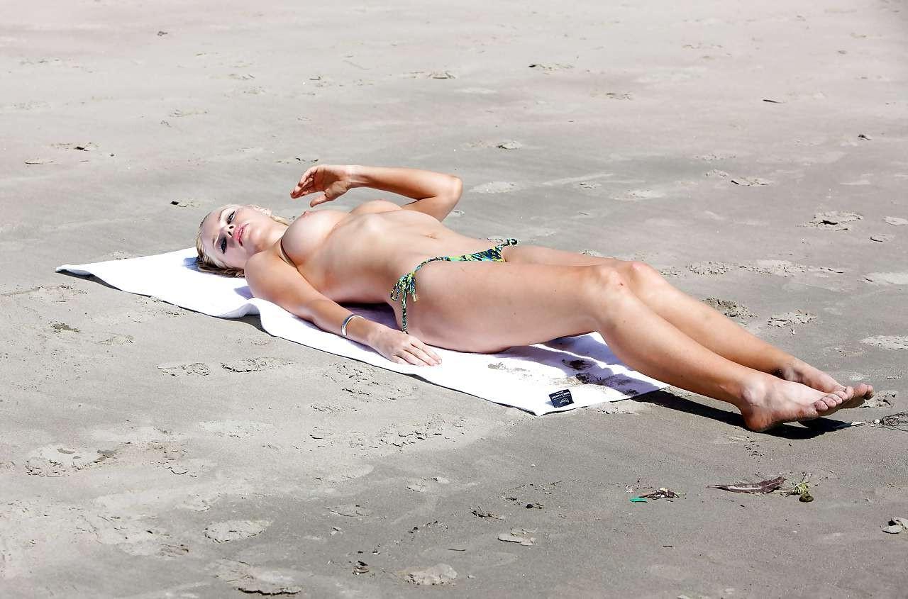 10P Sophie Monk exposing her huge boobs while sunbathing topless on beach