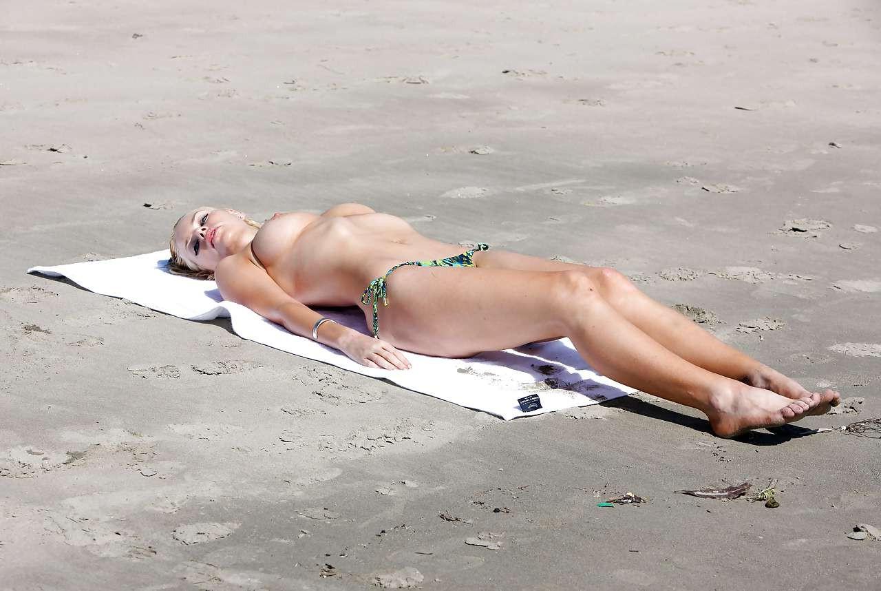 10P Sophie Monk exposing her huge boobs while sunbathing topless on beach