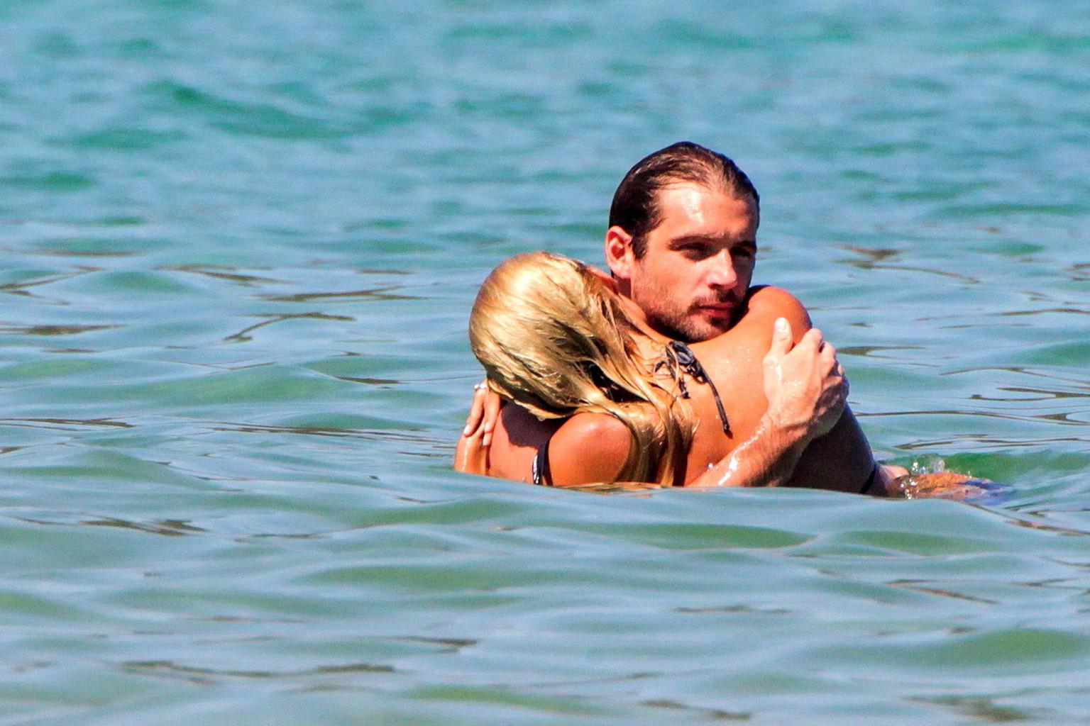 10P Michelle Hunziker in night camo bikini making out with her boyfriend on a beach 