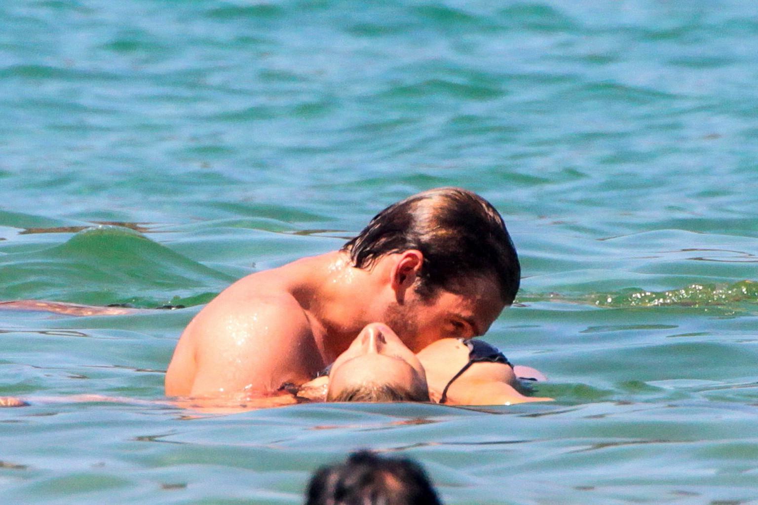 10P Michelle Hunziker in night camo bikini making out with her boyfriend on a beach 