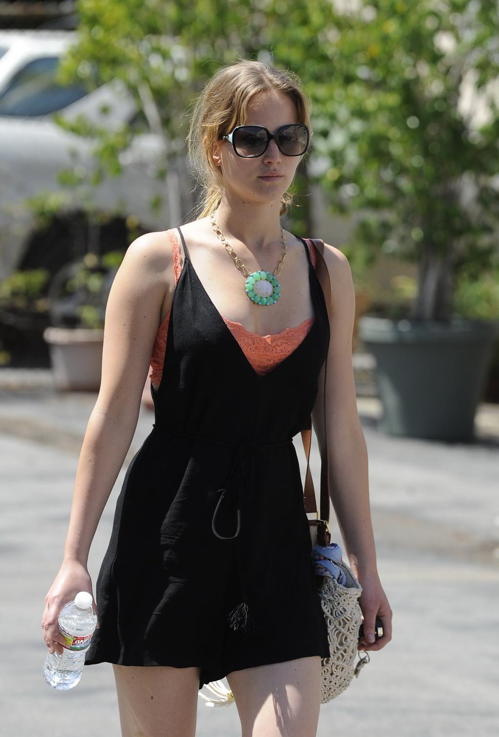 9P Jennifer Lawrence leggy and showing big cleavage in black low cut mini dress whi