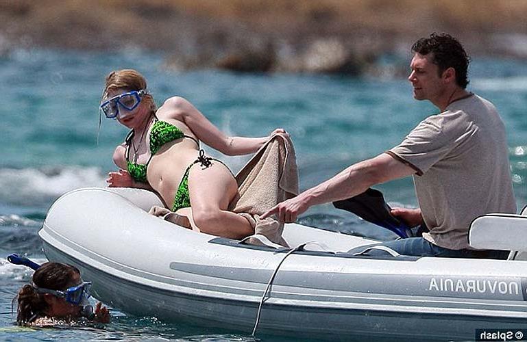10P Avril Lavigne exposing sexy bikini body in green bikini on yacht