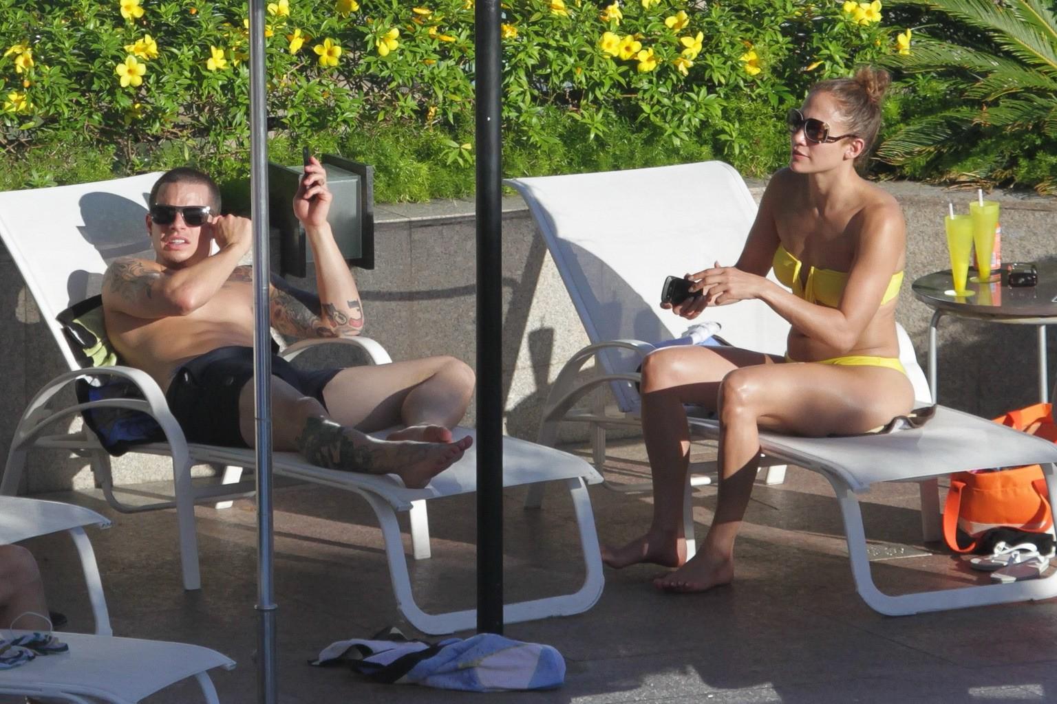 10P Jennifer Lopez showing off her  toned body wearing strapless canary bikini pools