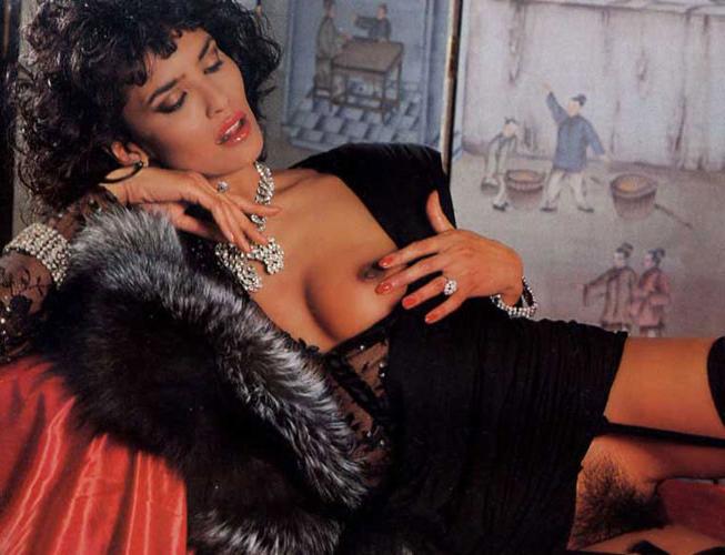 16P Laura Gemser body shows her tits and ass