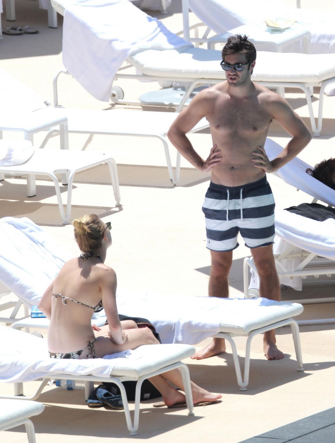 10P Emily VanCamp in snake print bikini petting with her boyfriend poolside in Monac