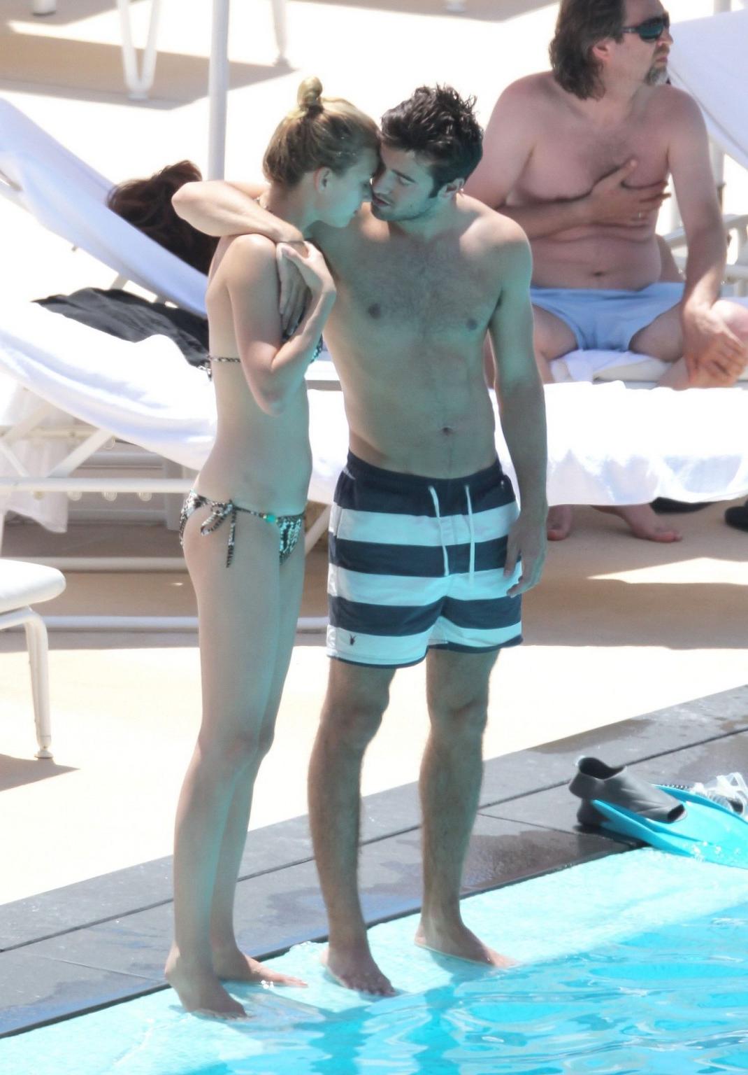 10P Emily VanCamp in snake print bikini petting with her boyfriend poolside in Monac