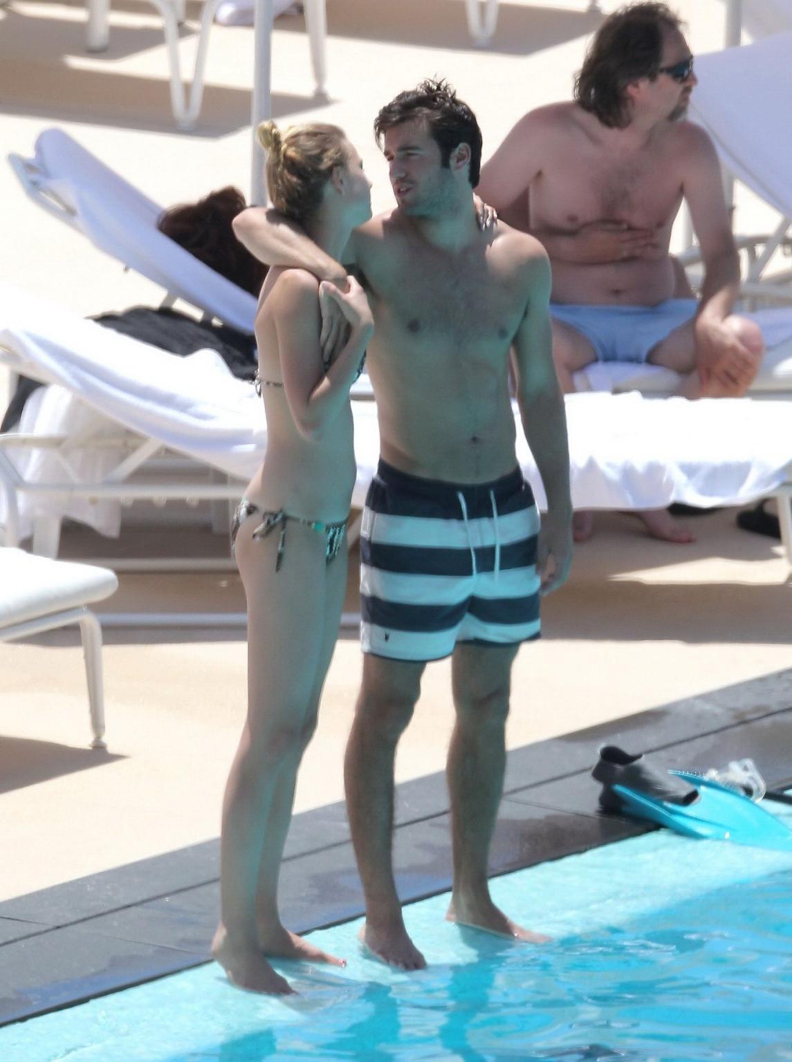 10P Emily VanCamp in snake print bikini petting with her boyfriend poolside in Monac