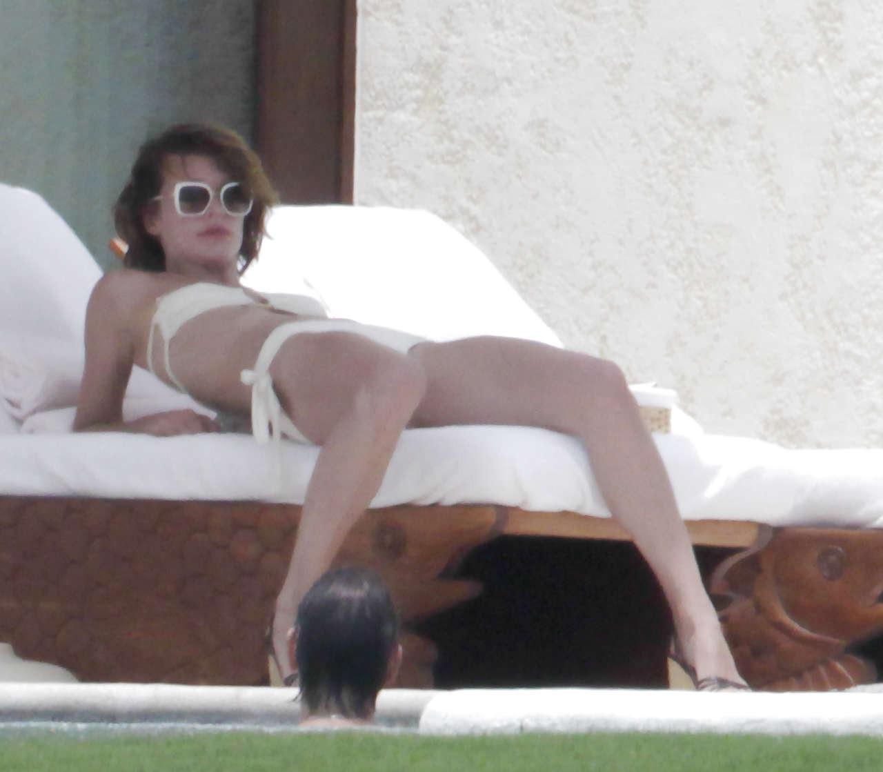 10P Milla Jovovich showing her ass in thong upskirt and topless in pool