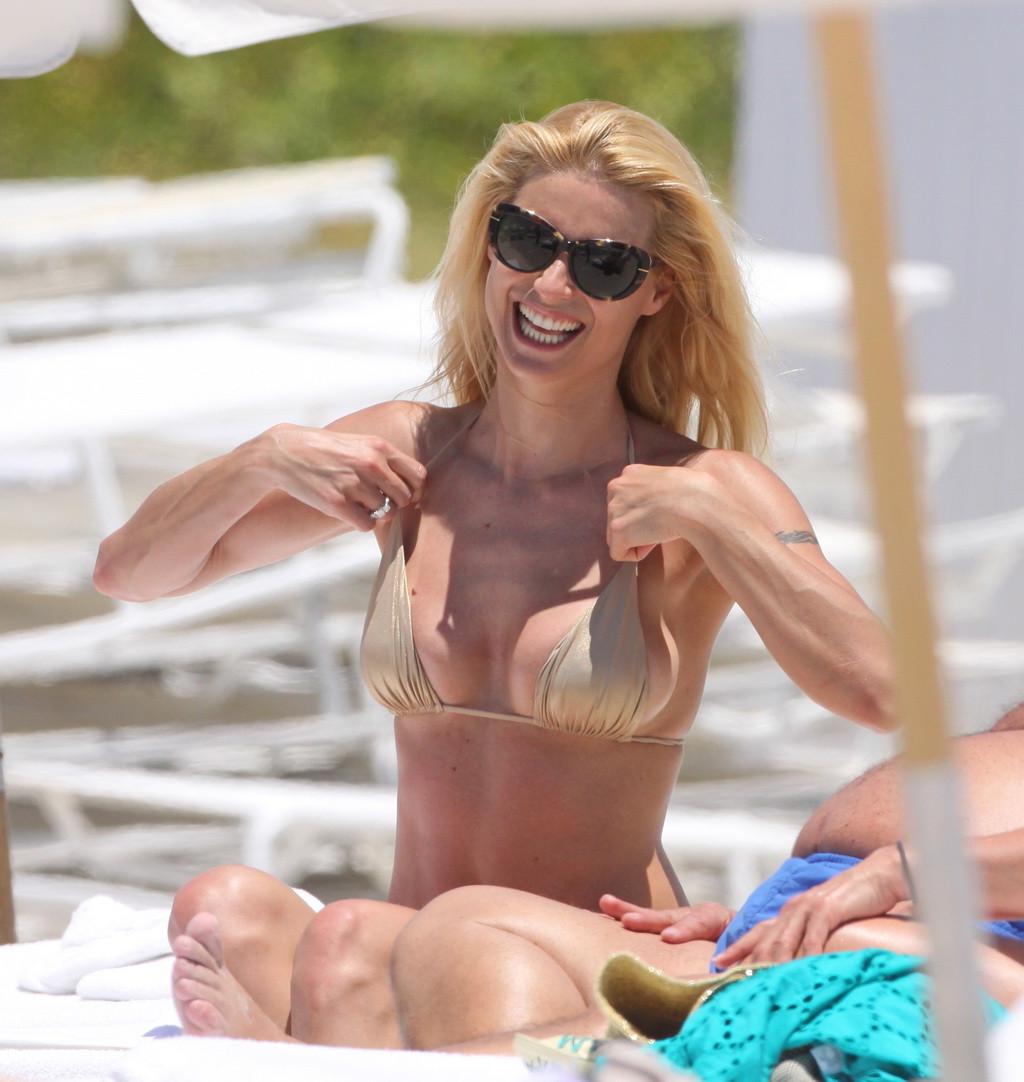 10P Michelle Hunziker wearing a gold bikini on the beach in Miami