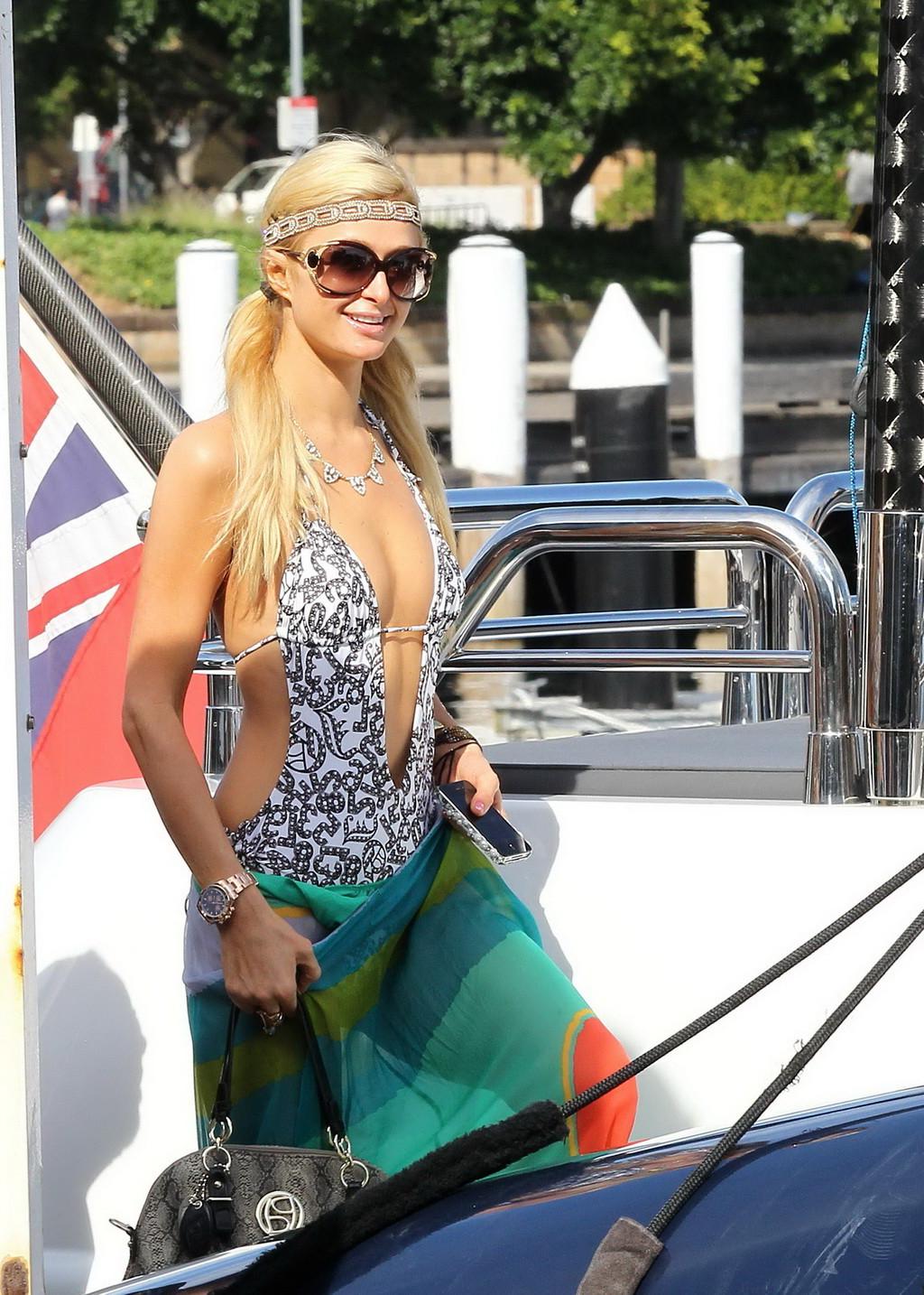 16P Paris Hilton showing her hot ass in deep cut swimsuit at the yacht in Sydney Har