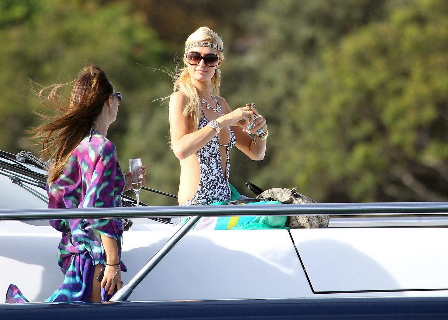 16P Paris Hilton showing her hot ass in deep cut swimsuit at the yacht in Sydney Har