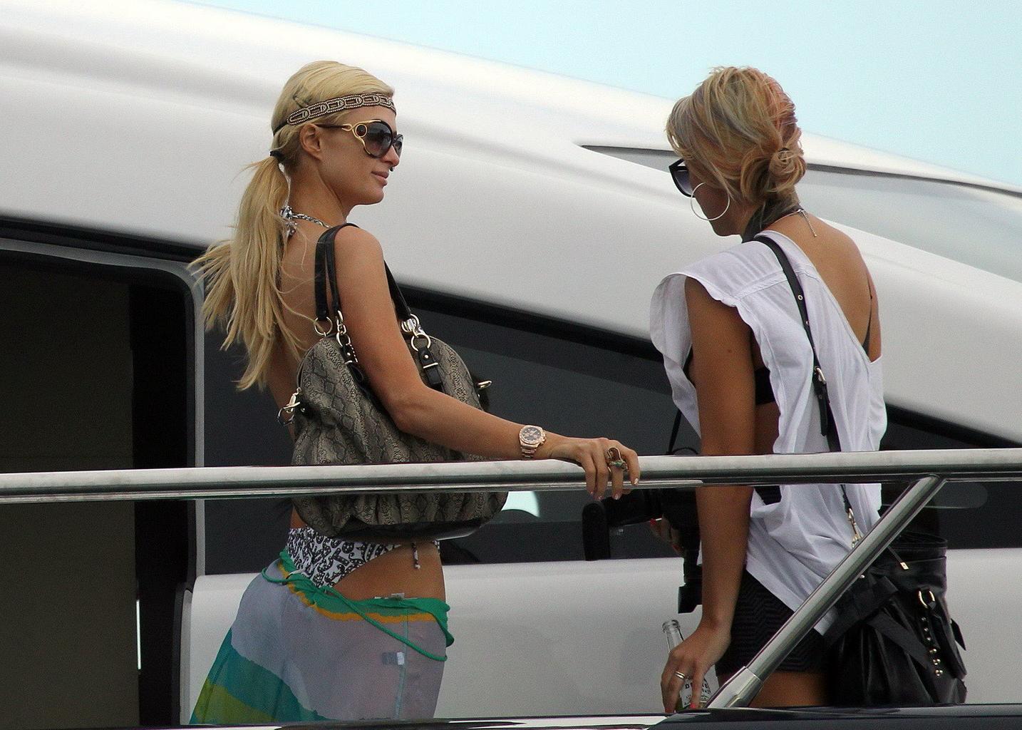 16P Paris Hilton showing her hot ass in deep cut swimsuit at the yacht in Sydney Har