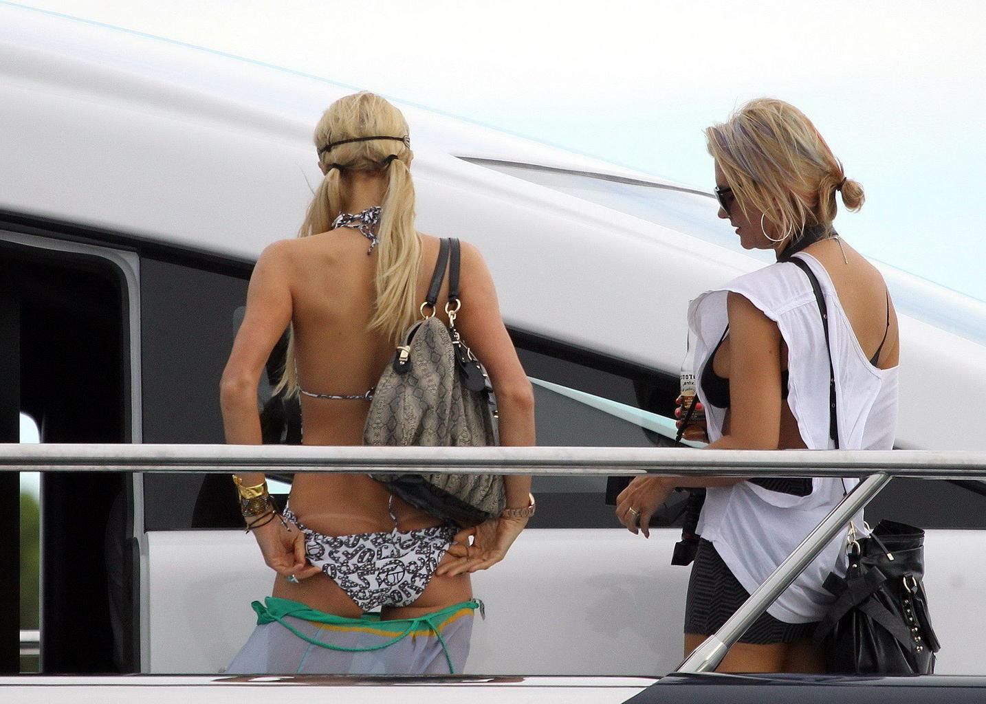 16P Paris Hilton showing her hot ass in deep cut swimsuit at the yacht in Sydney Har