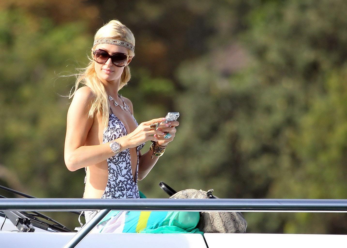 16P Paris Hilton showing her hot ass in deep cut swimsuit at the yacht in Sydney Har
