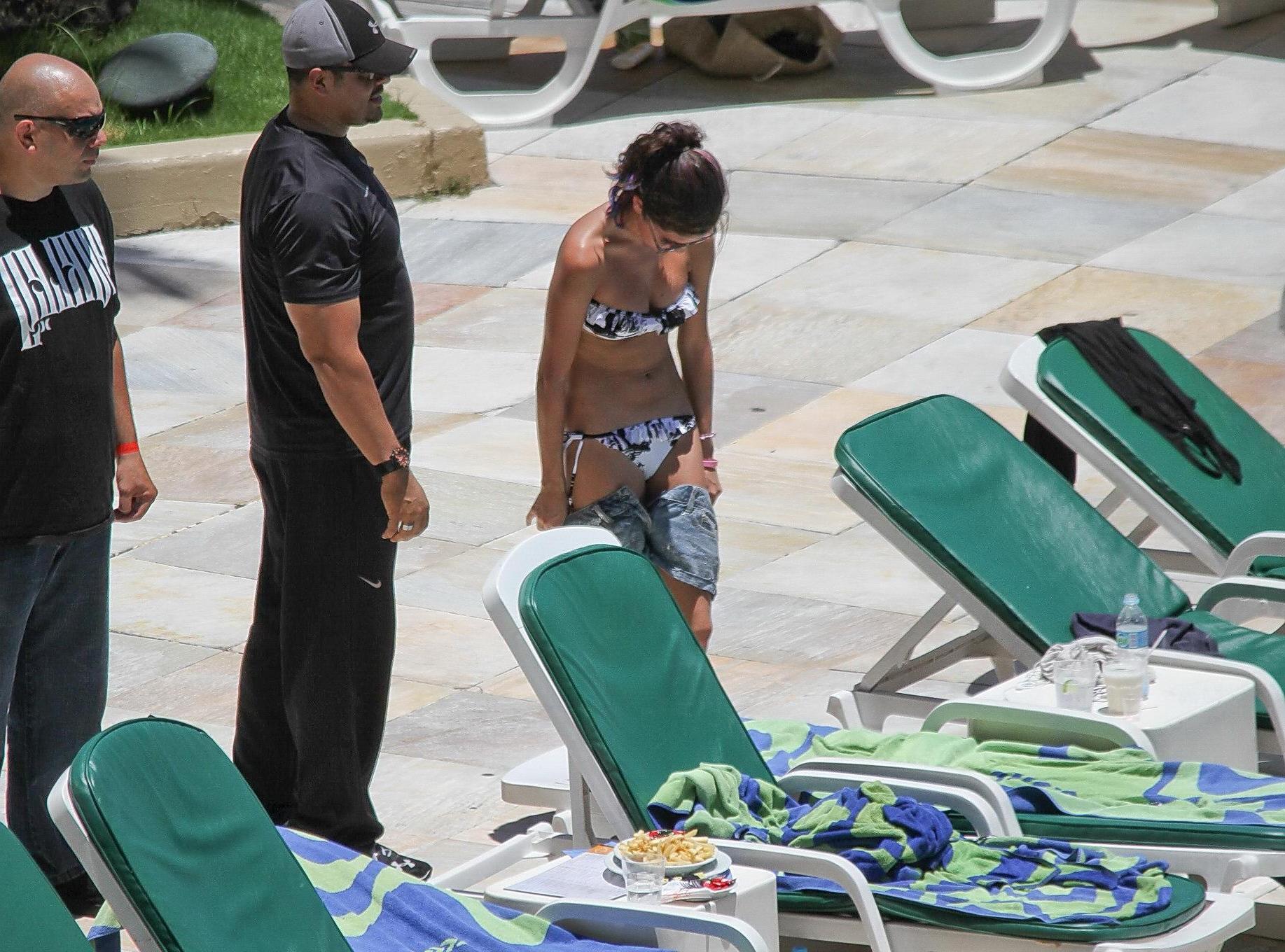 16P Selena Gomez sunbathing topless poolside in Rio de Janeiro