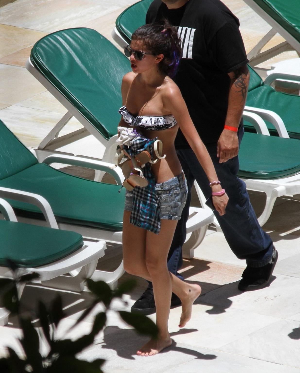 16P Selena Gomez sunbathing topless poolside in Rio de Janeiro
