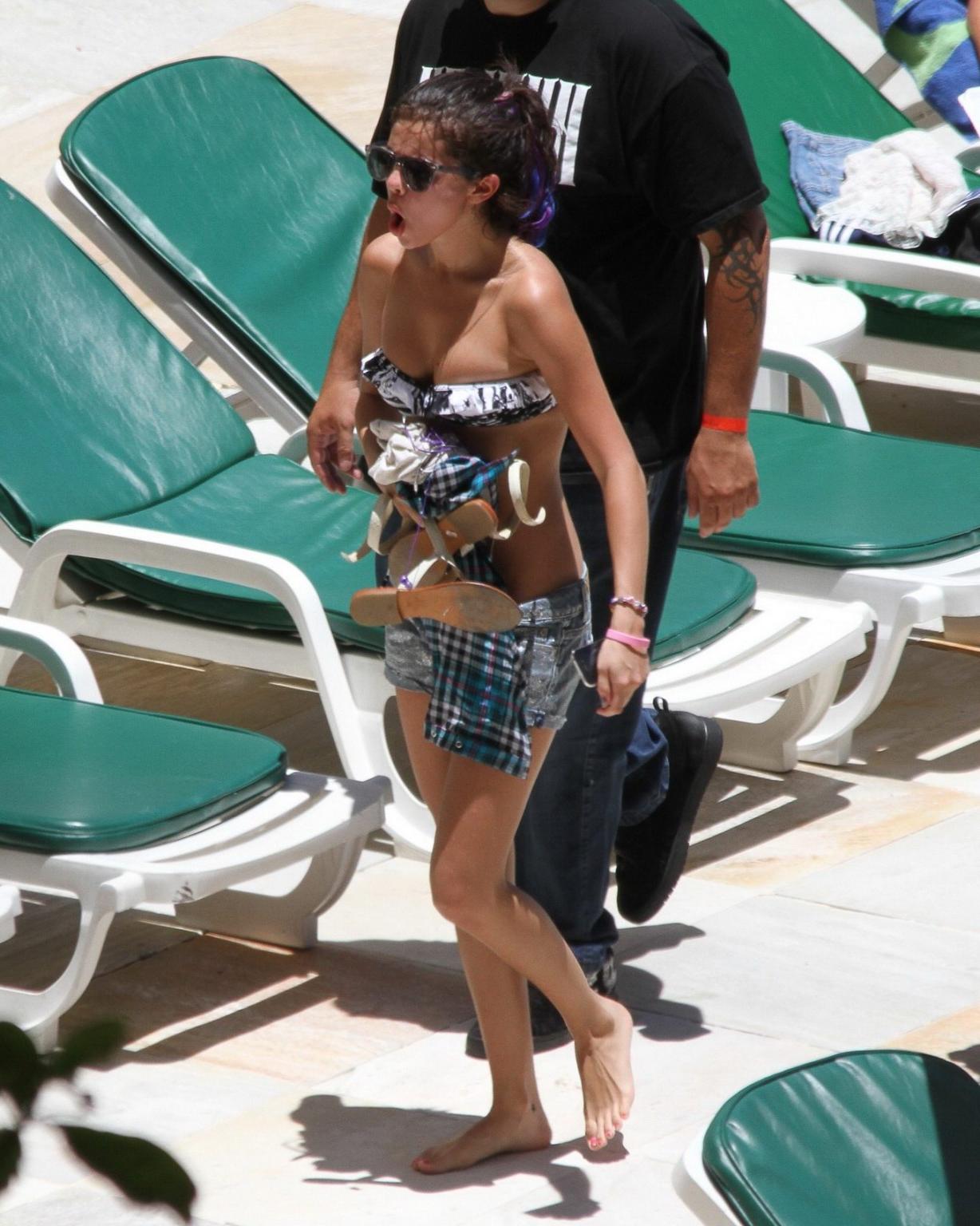 16P Selena Gomez sunbathing topless poolside in Rio de Janeiro