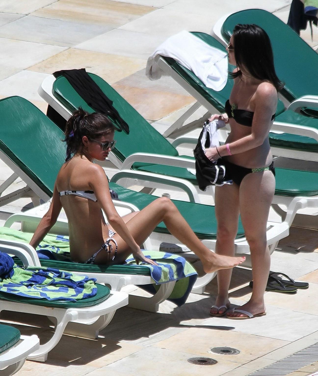 16P Selena Gomez sunbathing topless poolside in Rio de Janeiro