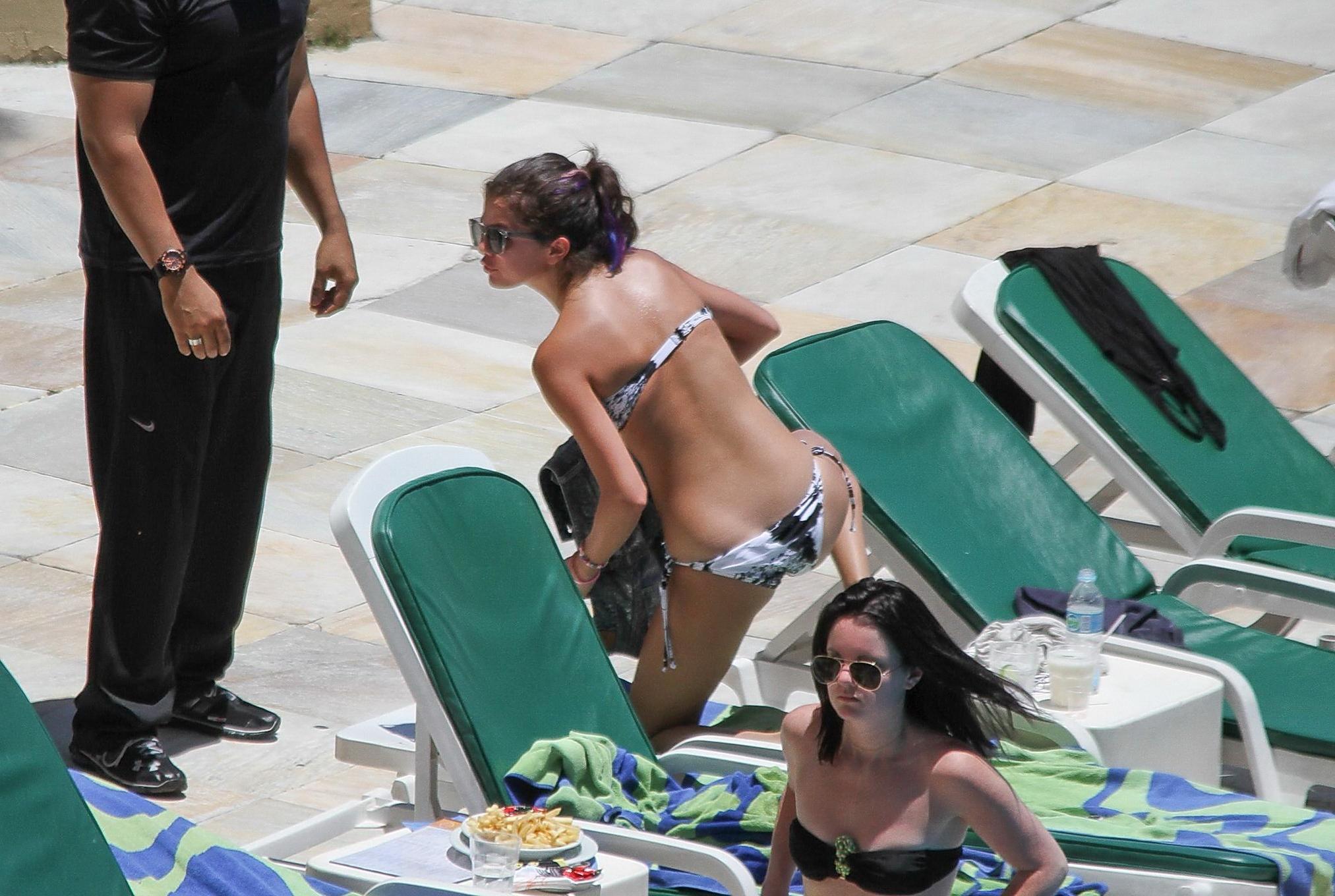 16P Selena Gomez sunbathing topless poolside in Rio de Janeiro