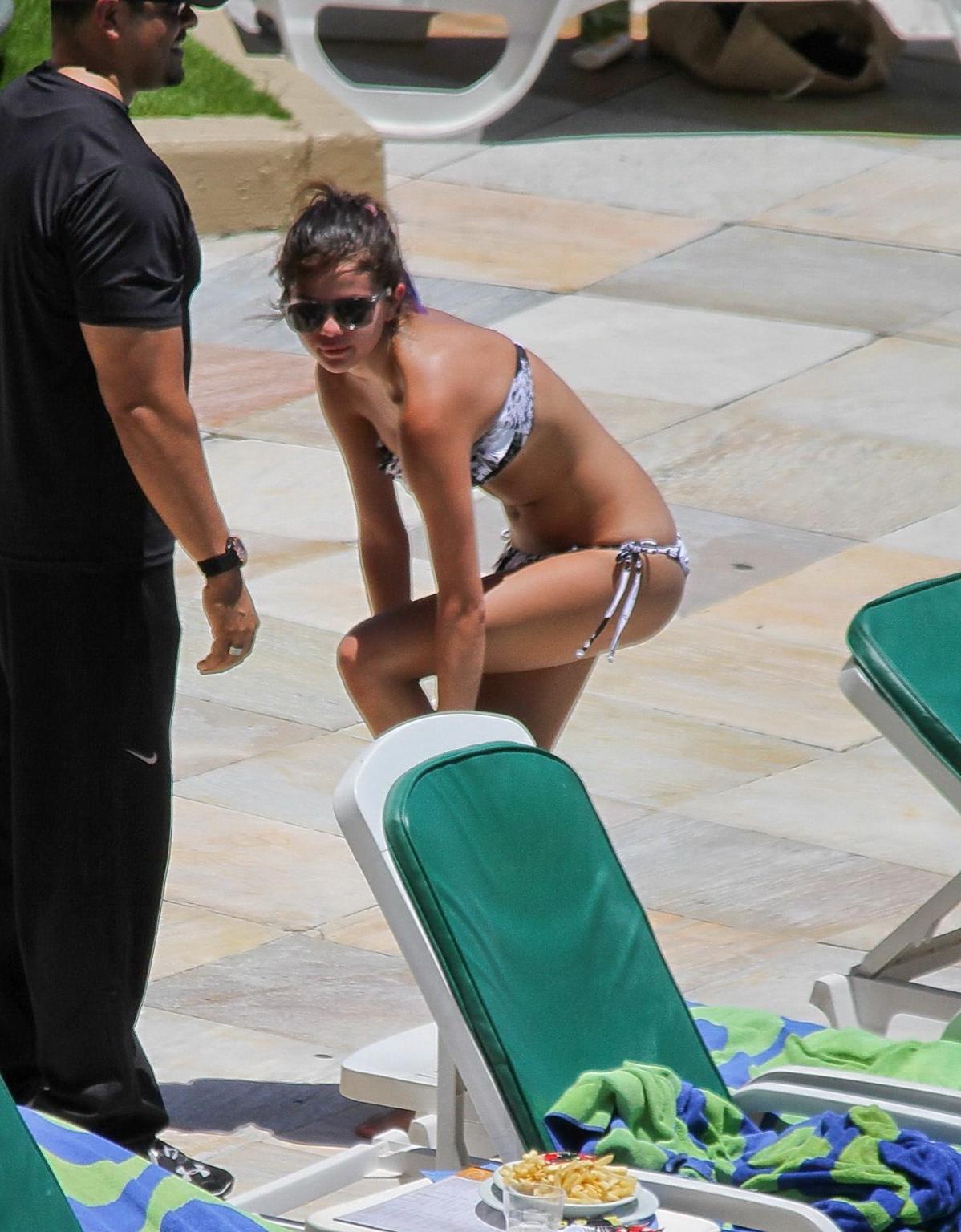 16P Selena Gomez sunbathing topless poolside in Rio de Janeiro