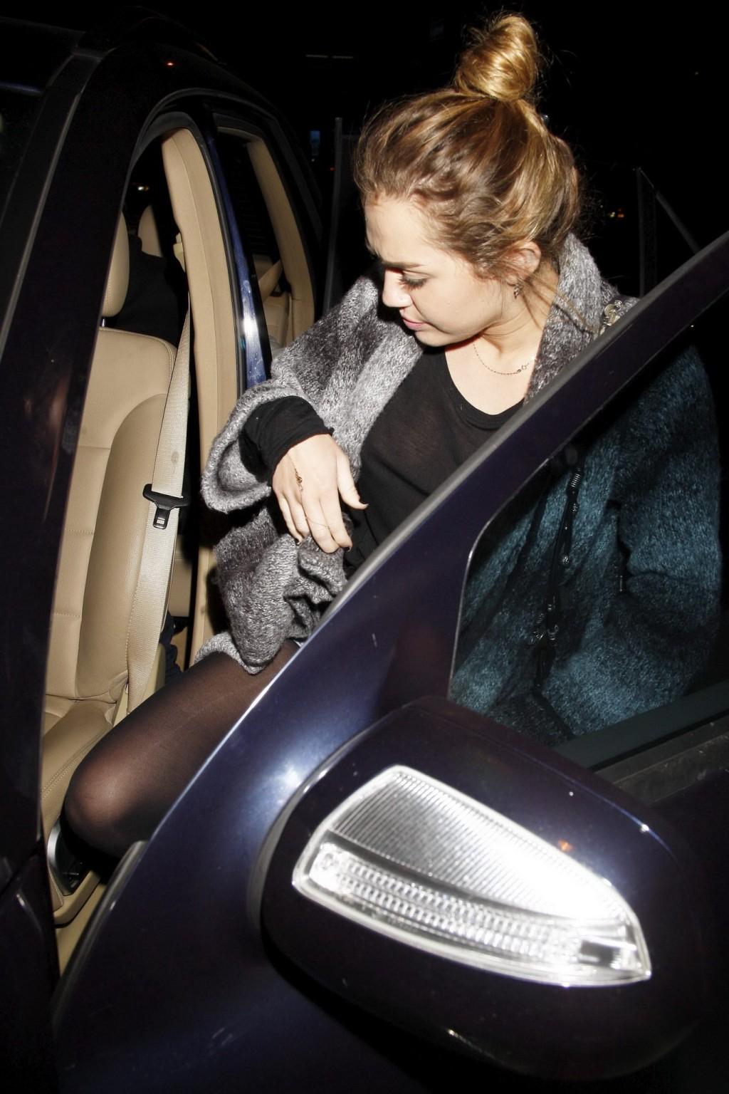 16P Miley Cyrus braless wearing black see through top outside a restaurant