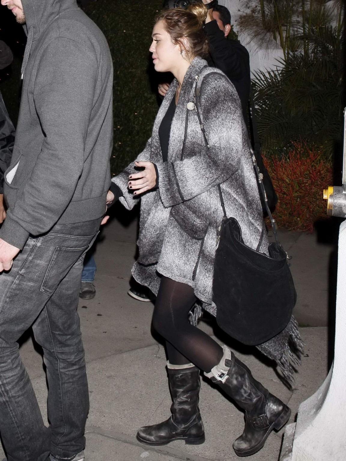 16P Miley Cyrus braless wearing black see through top outside a restaurant