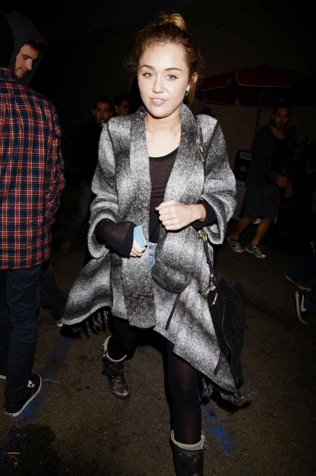 16P Miley Cyrus braless wearing black see through top outside a restaurant