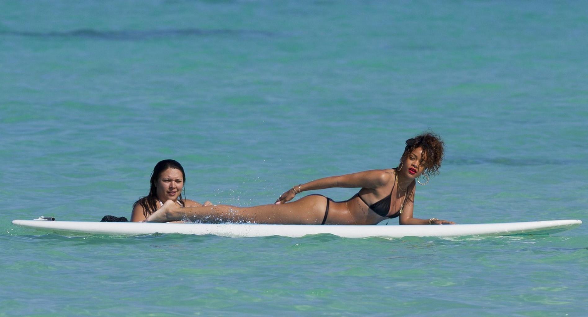 16P Rihanna shows off her ass wearing black thong bikini on a beach in Hawaii