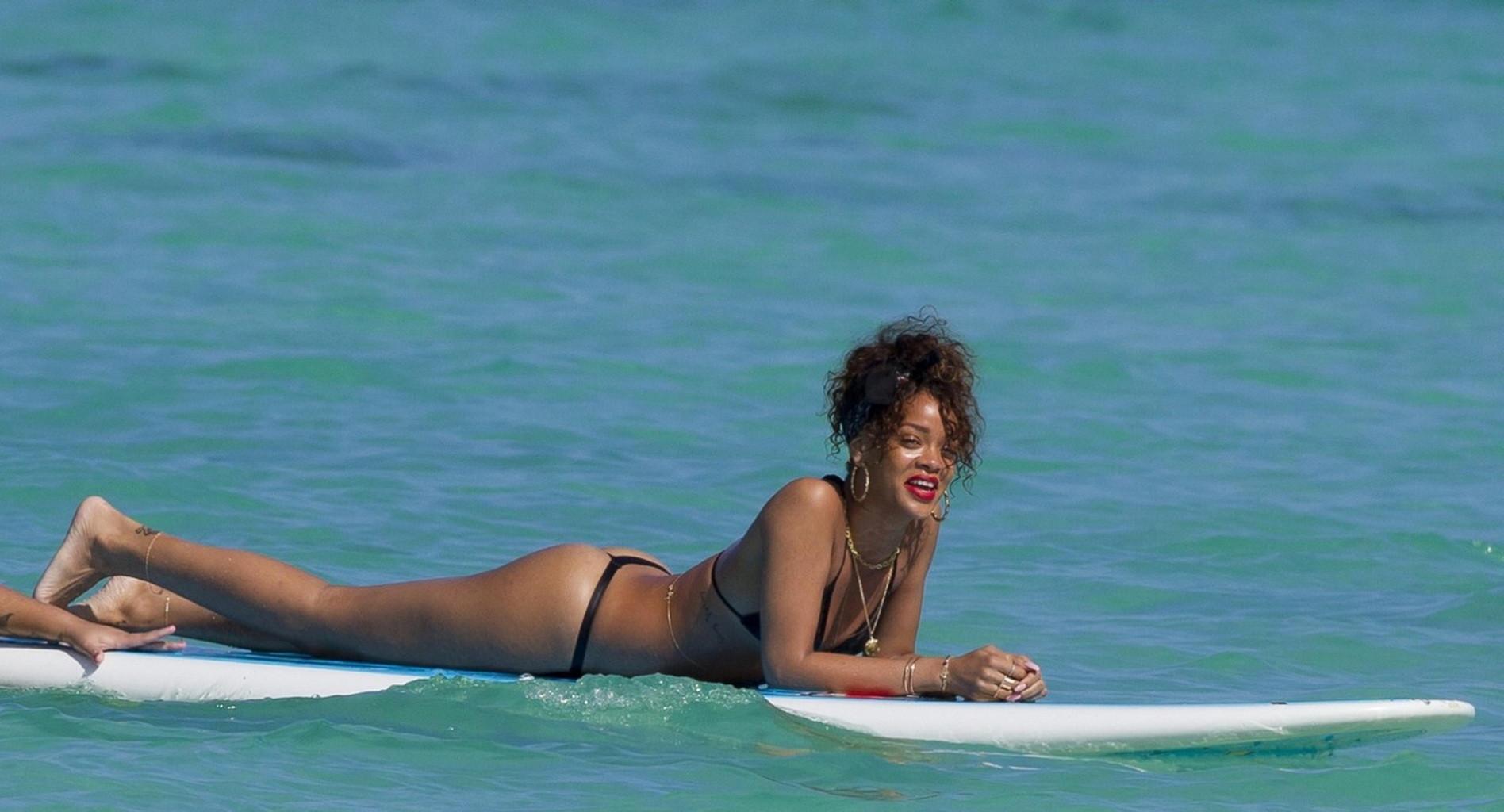 16P Rihanna shows off her ass wearing black thong bikini on a beach in Hawaii