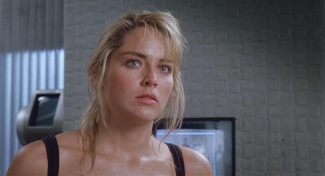 16P Sharon Stone show big cleavage in red top and exposing her tits