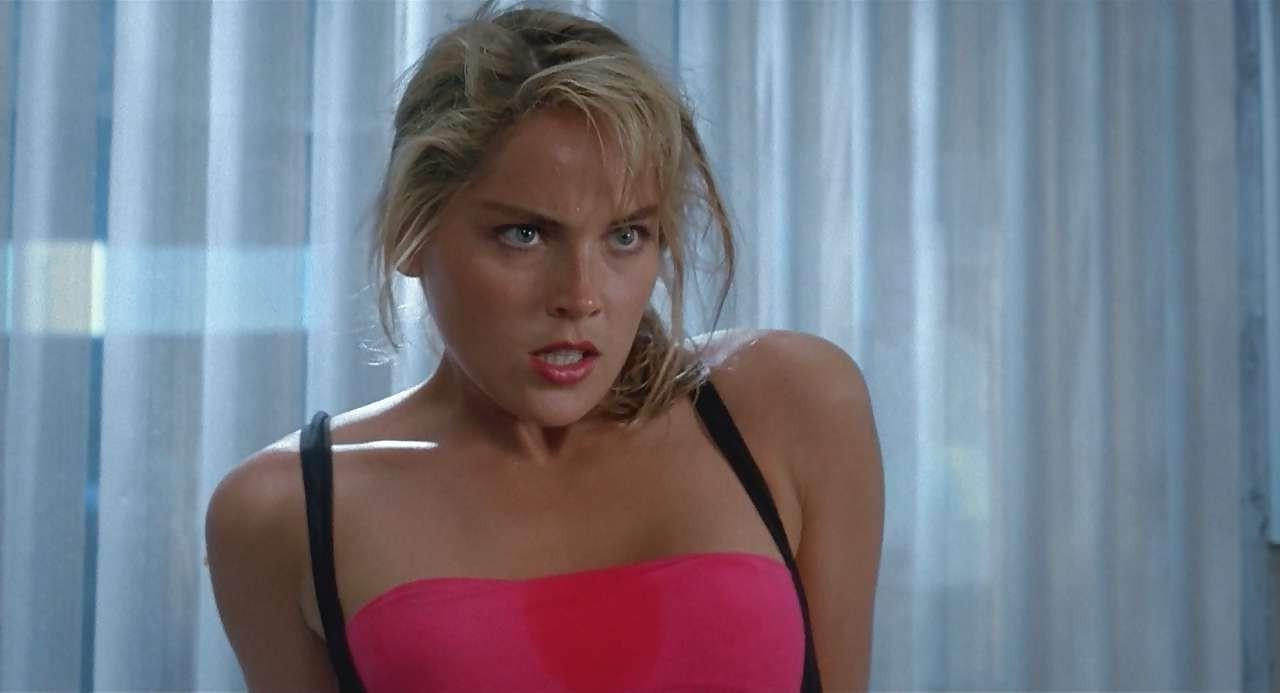 16P Sharon Stone show big cleavage in red top and exposing her tits