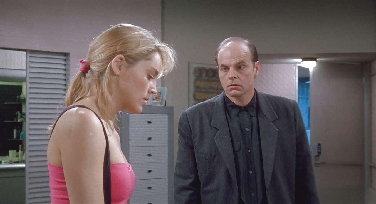 16P Sharon Stone show big cleavage in red top and exposing her tits