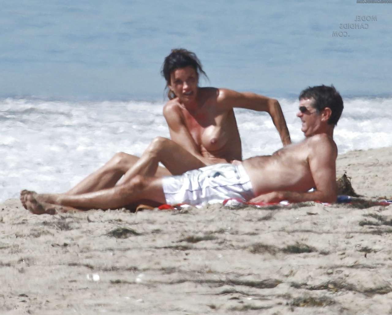 16P Janice Dickinson showing her nice big tits on beach paparazzi pictures