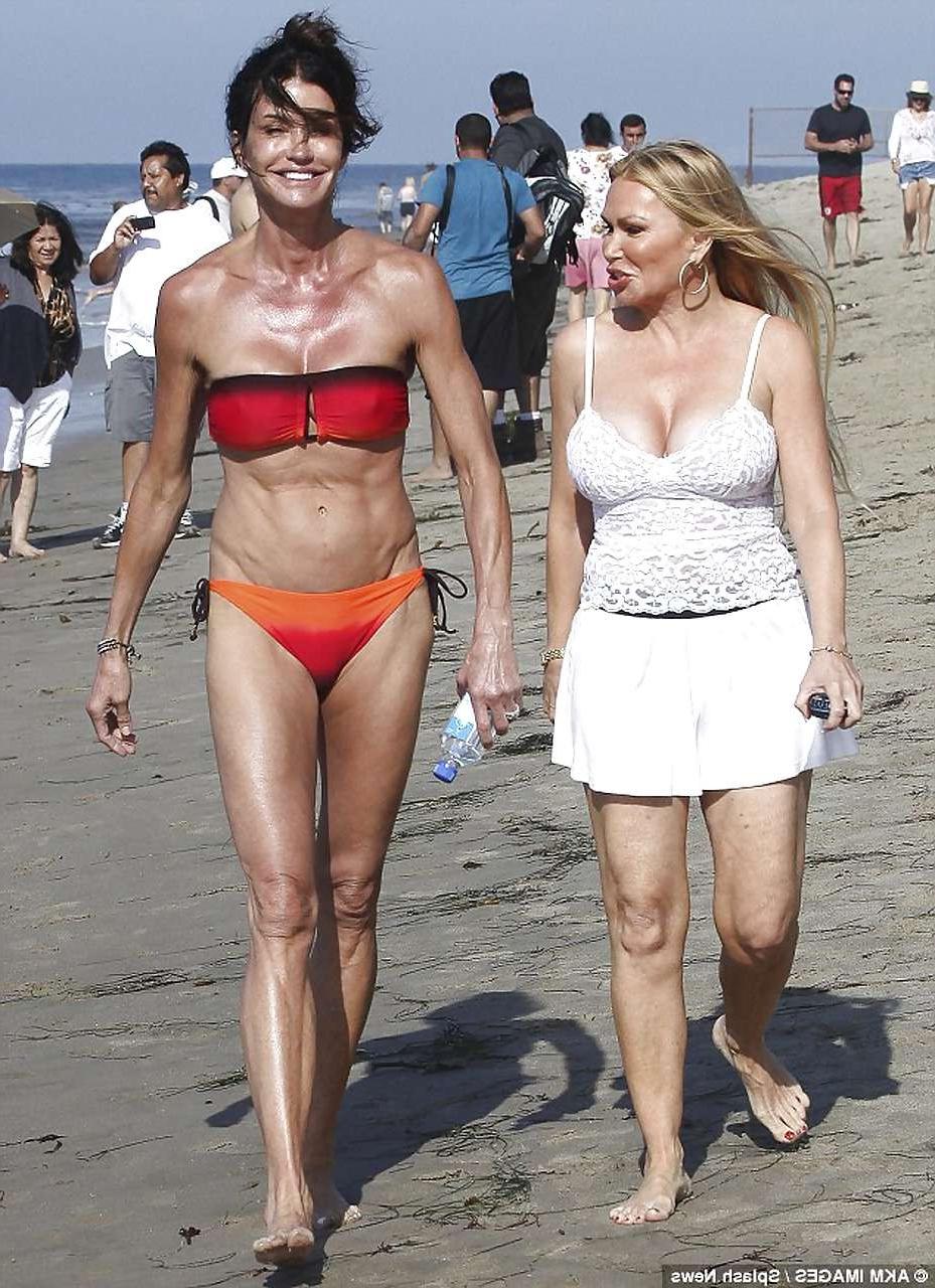 16P Janice Dickinson showing her nice big tits on beach paparazzi pictures