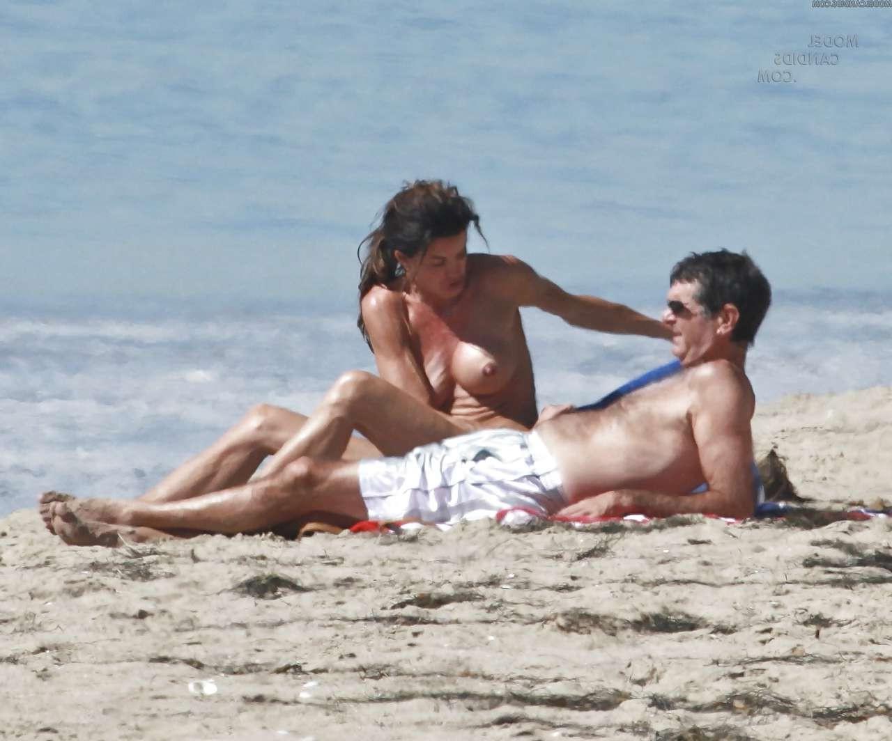16P Janice Dickinson showing her nice big tits on beach paparazzi pictures